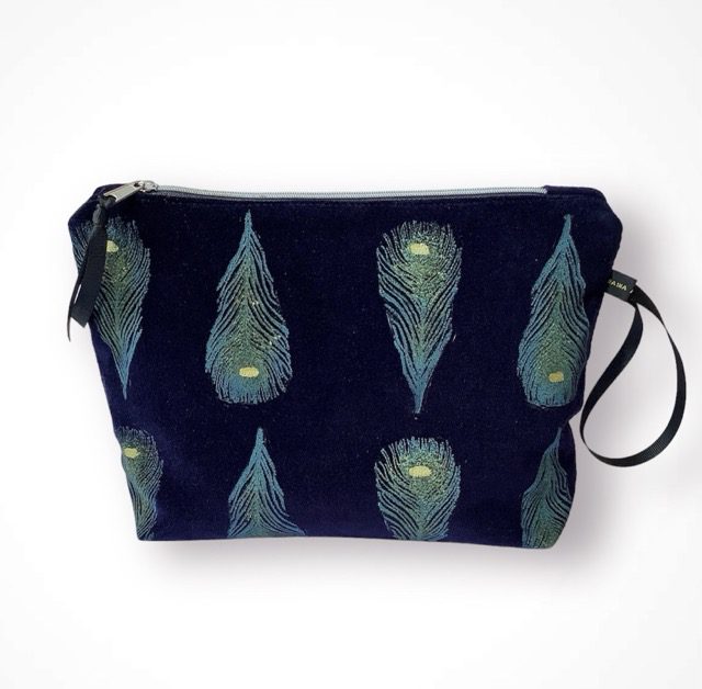 Luxury navy velvet makeup bag with blue peacock feathers print with golden shimmer