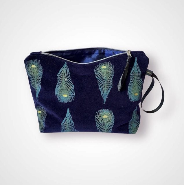 Luxury navy velvet makeup bag with blue peacock feathers print with golden shimmer