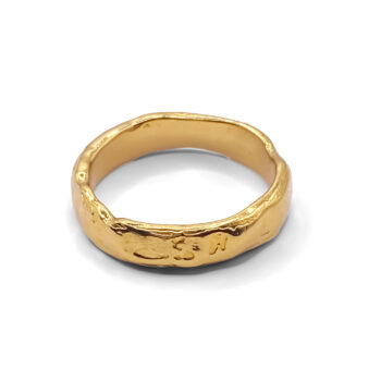 Textured gold ring on white background