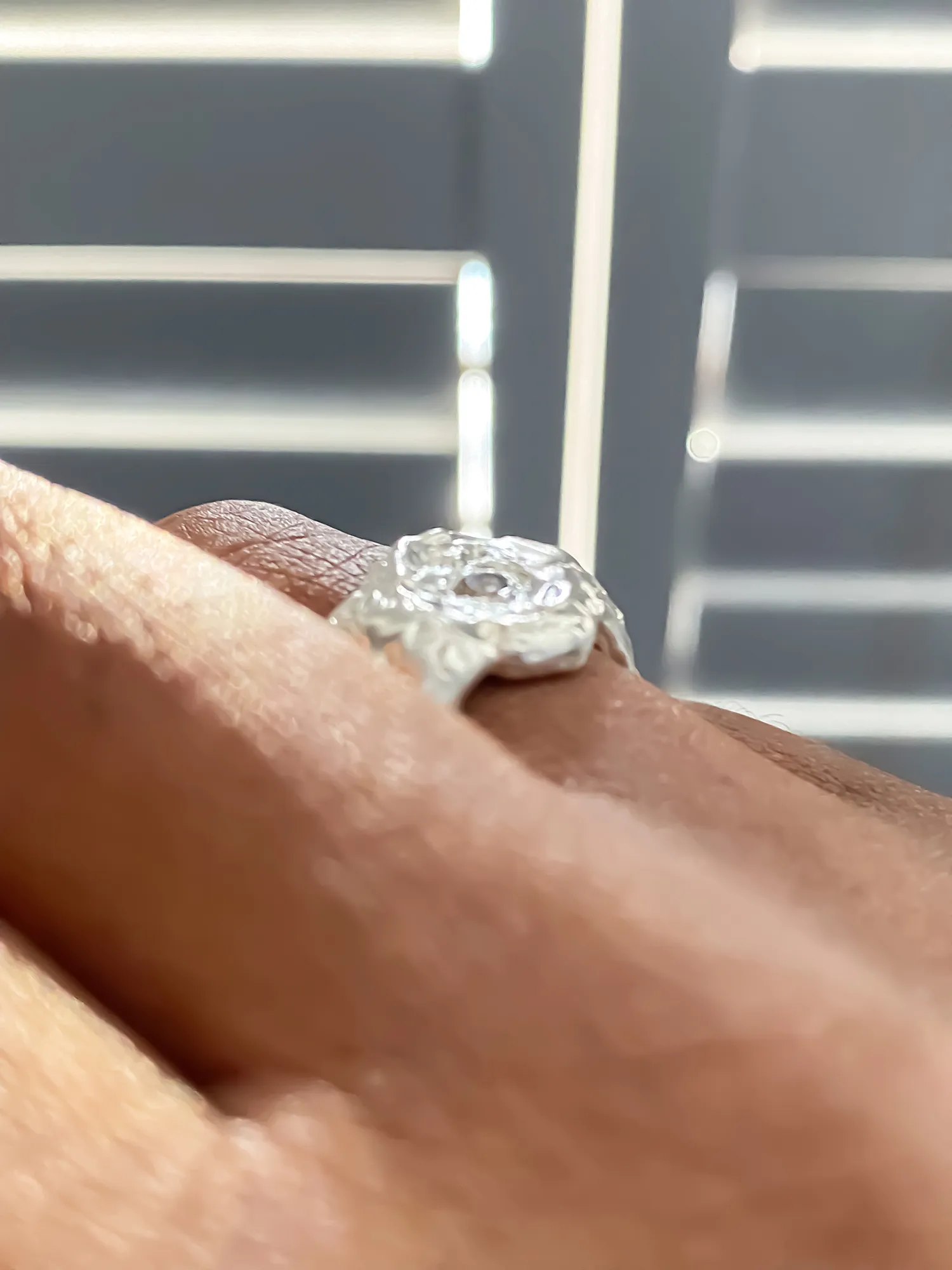 Handcrafted silver ring with gemstone worn on hand