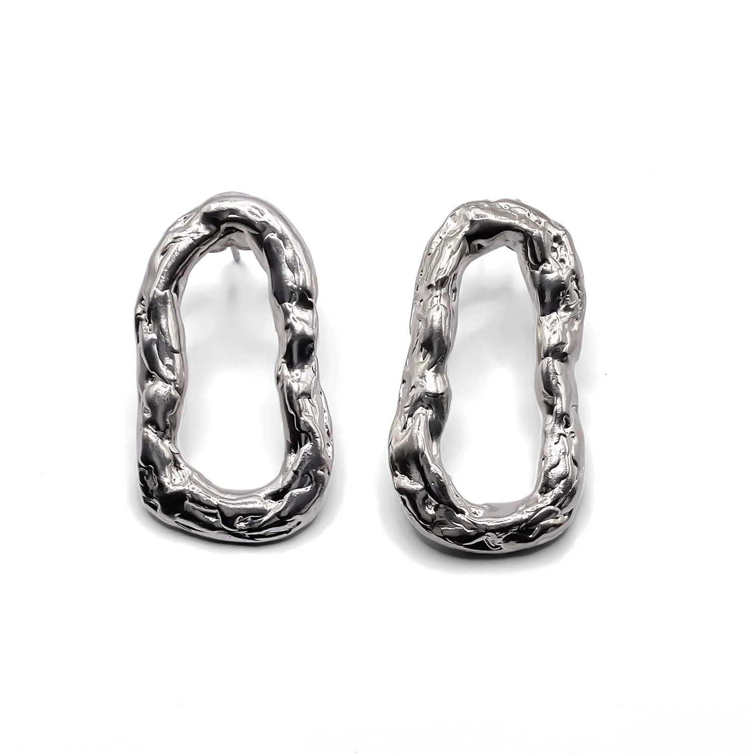 Pair of silver Flow Loop Earrings on white background, showing organic surface detail