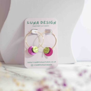 Pink and green circle-shaped leather on 30mm gold plated hoops, displayed on a neutral background