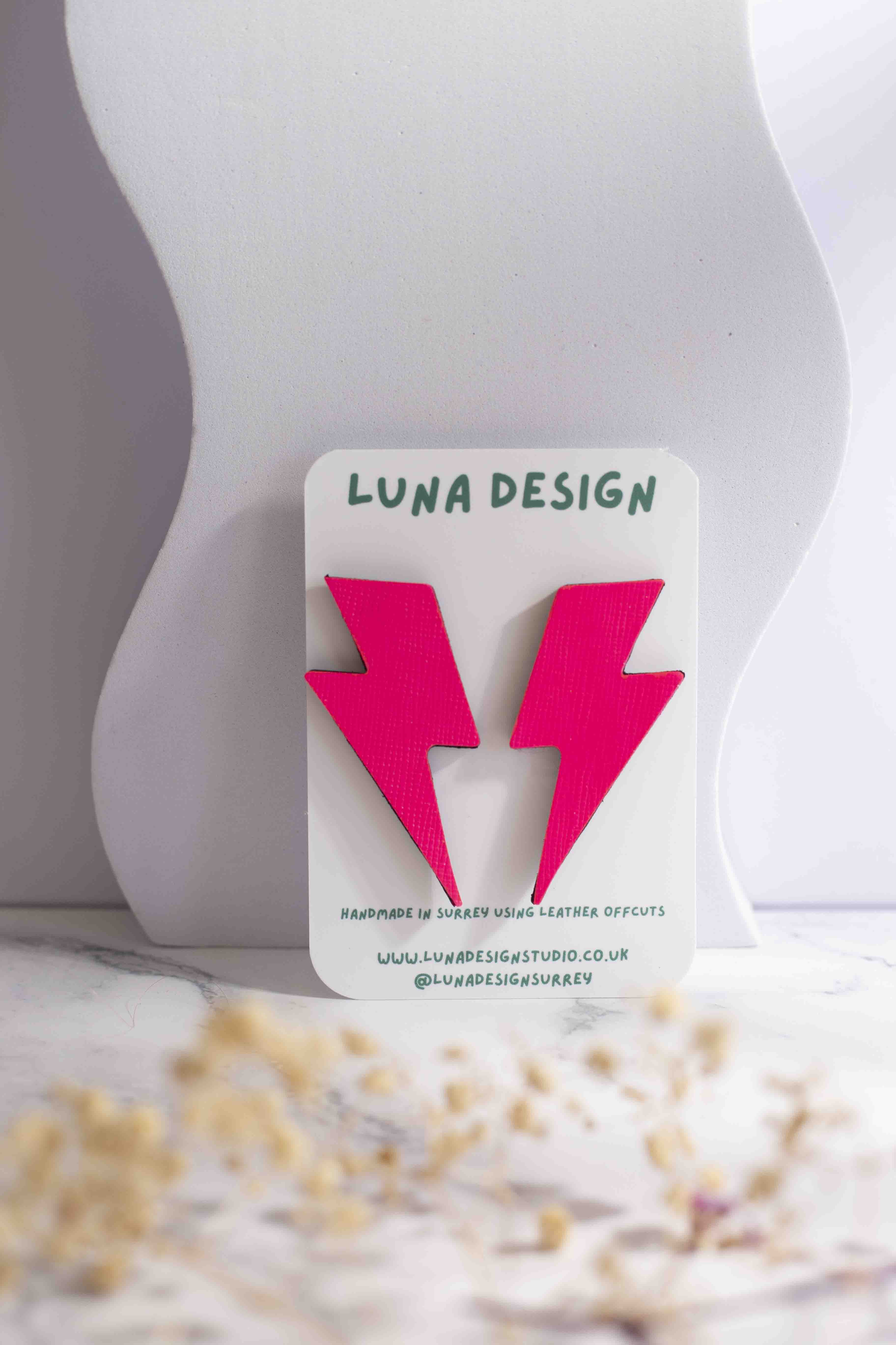 Extra-large neon pink lightning bolt stud earrings