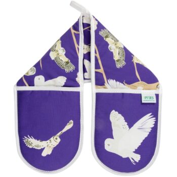 Bright purple oven gloves with illustrations ion owls including barn owl in flight over hand part of the left glove